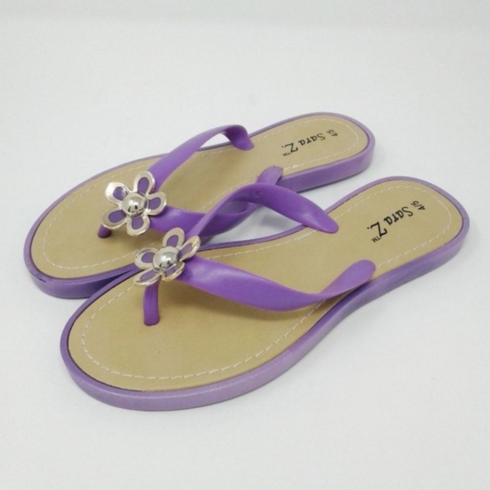 Sara Z. purple jelly flip flops daisy detail